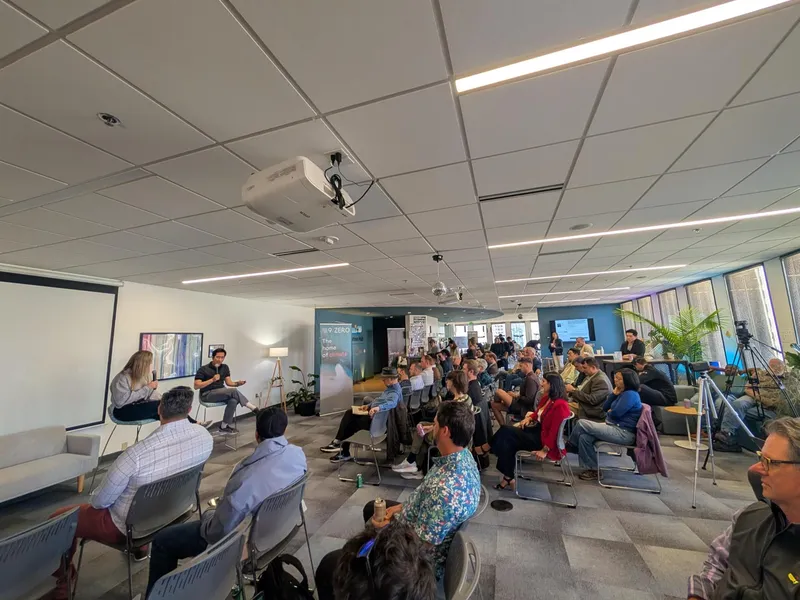 Chris speaking in a fireside chat in front of a crowd at 9Zero Climate Innovation Hub